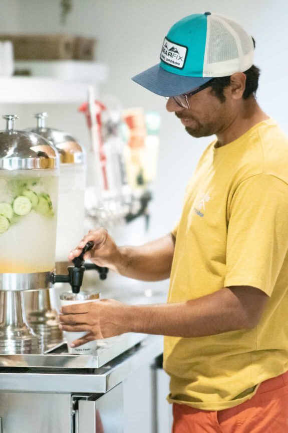A Haven member pouring himself a glass of cucumber infused water.
