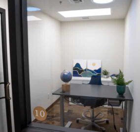 A private office at The Haven, with a desk, chair, and decorations.