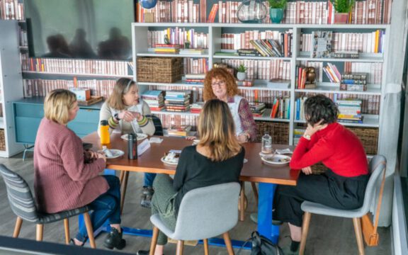 A group of female community members meeting in The Library at The Haven.