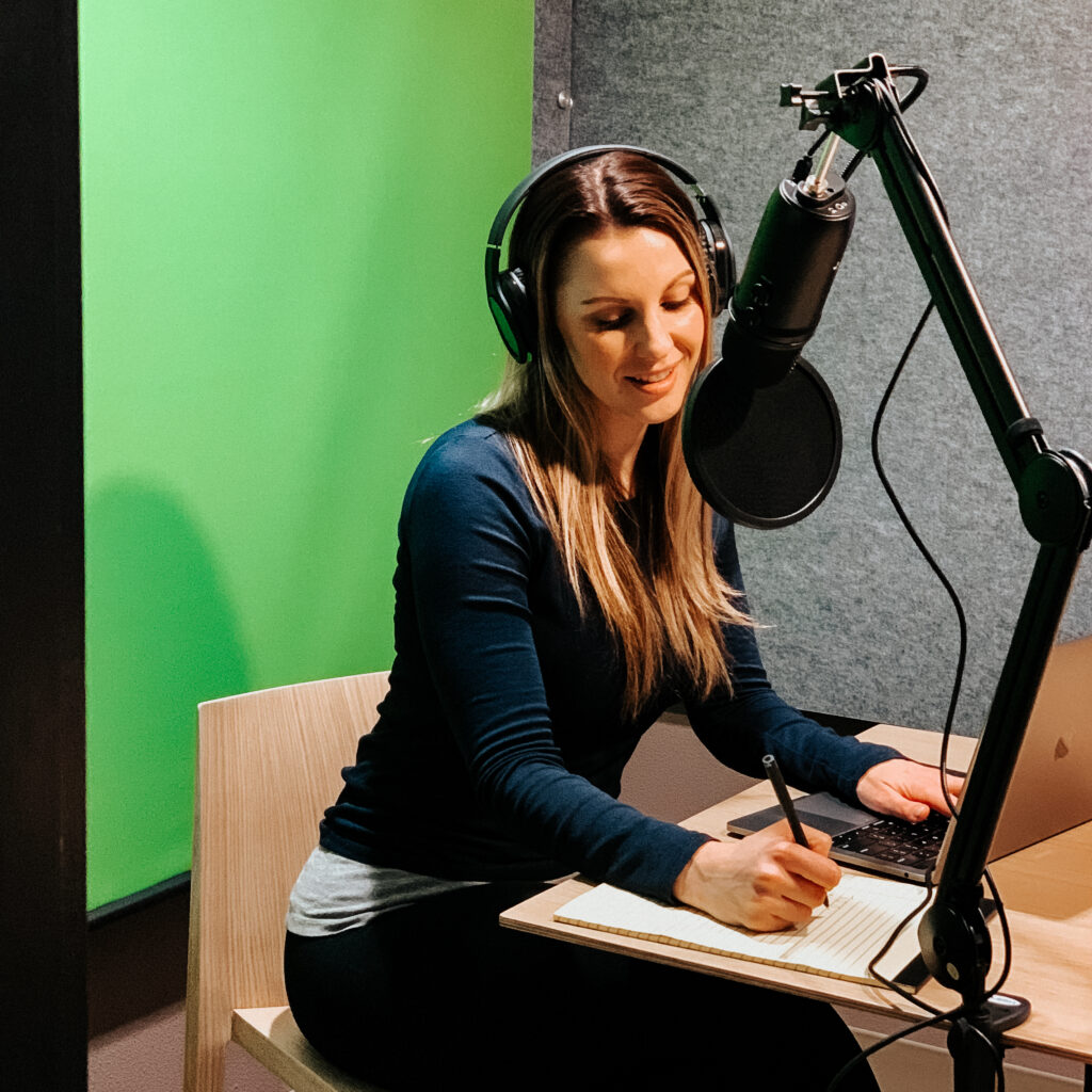 woman poses in a podcasting room in a coworking space Bend, Oregon