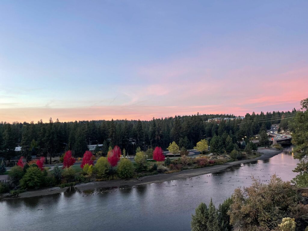 Southern views of Bend, Oregon with pink sky as the sun rises over the Deschutes River